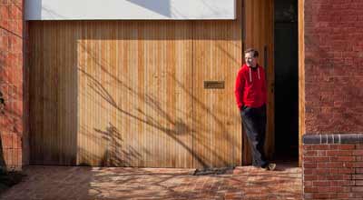 John Christophers in the doorway of zero carbon house, Birmingham