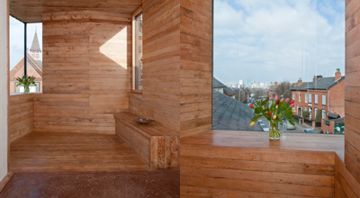 The wooden alcove in the studio in zero carbon house, Birmingham showing the view over Tindal St