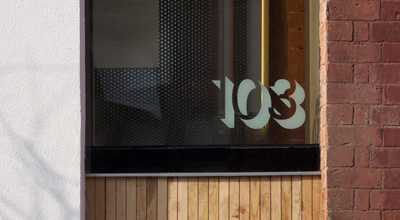 Letters 103 etched into the glass sky light above the door of zero carbon house, Birmingham