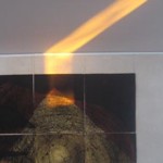 A shaft of light on Jake Lever's golden hands artwork in zero carbon house, Birmingham