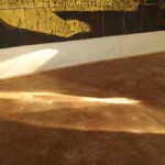 Light falls on the rammed earth floor at zero carbon house Birmingham