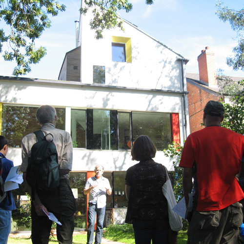 People in the garden at the zero carbon house Birmingham at the Superhomes open day