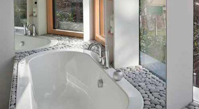 Bathroom at zero carbon house, Birmingham showing bath and taps and pebbles