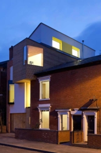 The front of zero carbon house, Birmingham after dark with the lights on