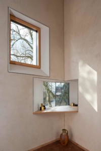 Two windows in the studio of zero carbon house. Birmingham showing the back garden