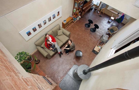 John and Theo on sofa with Jo on chair beside on the ground floor of zero carbon house, Birmingham