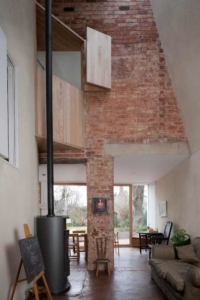 Living room in zero carbon house Birmingham showing the full height windows