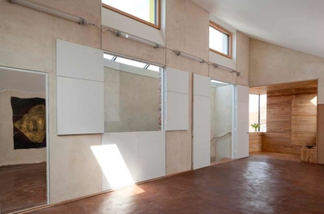 The Long room at zero carbon house, Birmingham showing the shutters open. They are used for ventilation