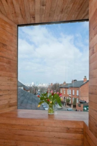 Tulips on the window sill of the studio at zero carbon house, Birmingham showing the Birmingham skyline and Tindal Street